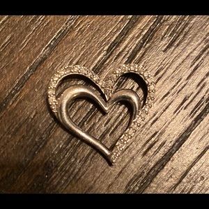 Sterling silver and diamond heart pendant.
